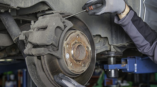 Squealing brakes being replaced in auto repair shop